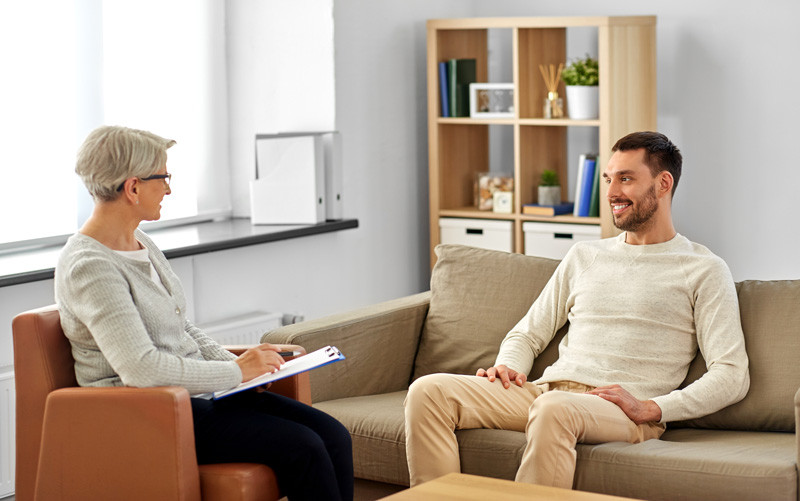 EVERMOORE A clinician and an adult speaking in a calm care setting